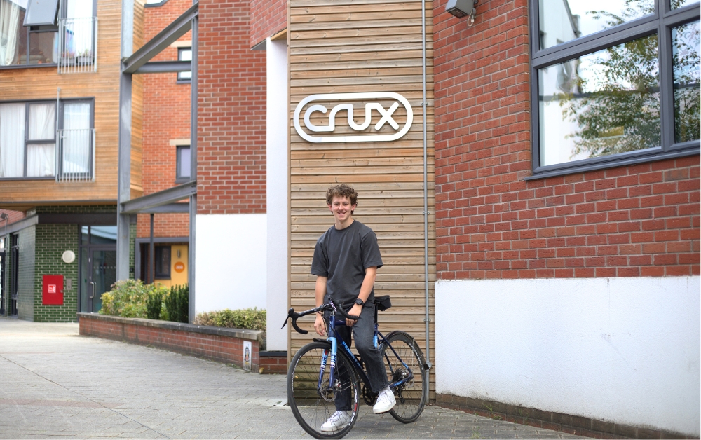 Image: Evan Davies, mechnical engineering intern from Crux on his bike outside the office